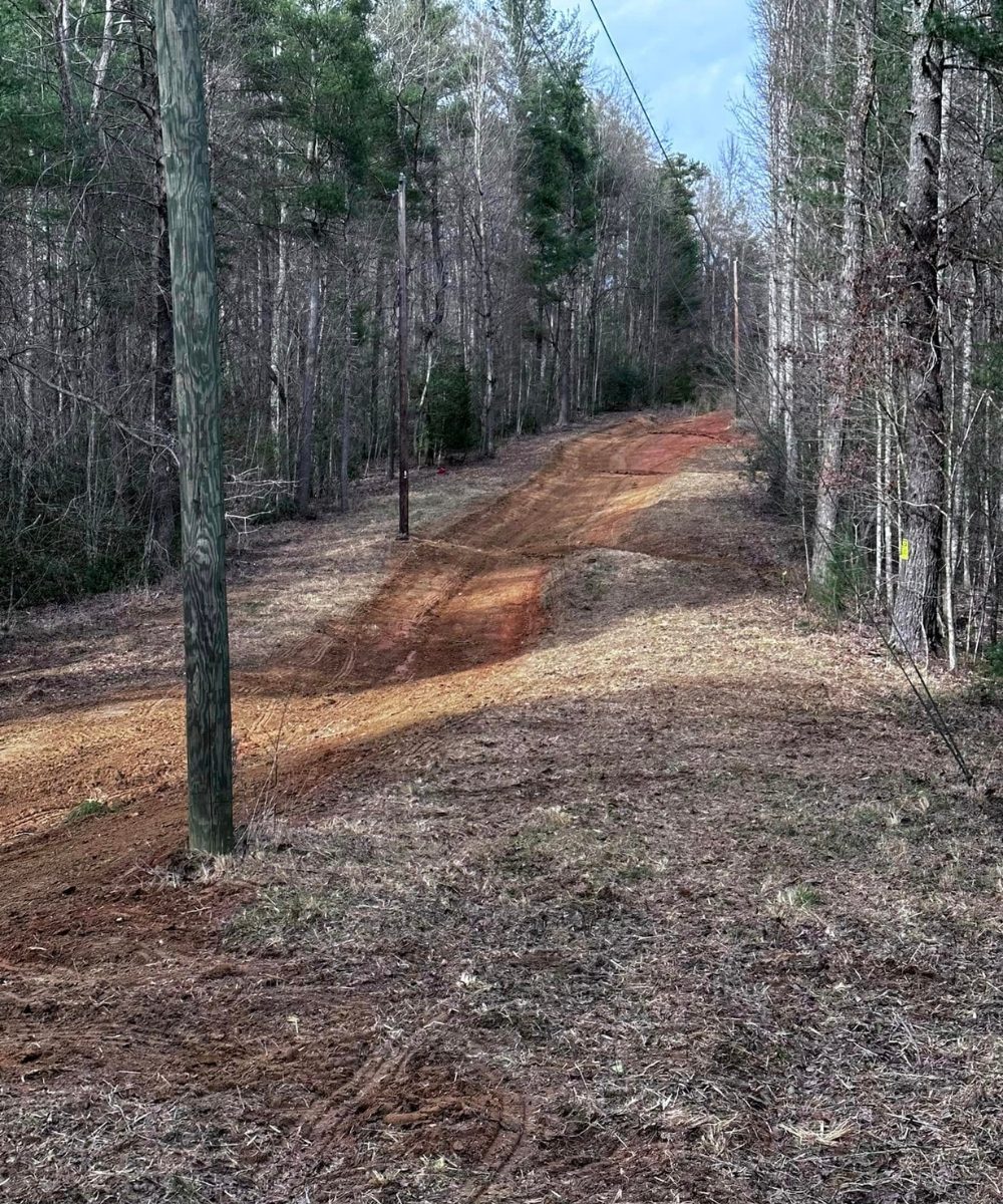 Land clearing, bush hogging, & septic tanks Jefferson NC job site being worked on with a new road being installed.