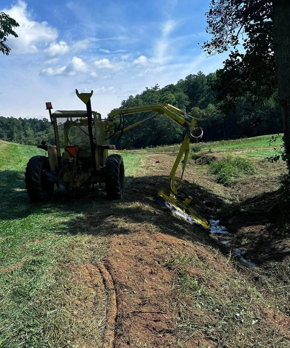 Professional doing land clearing, bush hogging, & septic tanks on a jobsite in Boone, NC